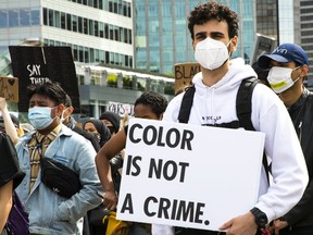 A protester attends an anti-racism rally at Jack Poole Plaza in Vancouver on Friday.