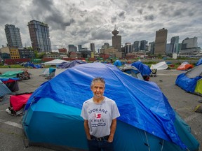 James Stevenson Low beside his tent with other homeless people living in CRAB Park near Burrard Inlet on Wednesday.