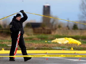 Abbotsford police Const. Rob Vroom, who died in 2018, investigates a suspicious death in the Parking lot of the Yellow Barn Produce Store on Number 3 Road in Abbotsford, in 2009.