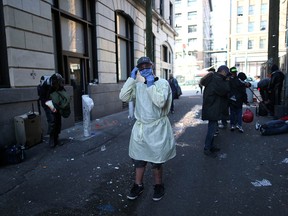 Support worker Thomus Donaghy adjusts his protective mask outside the Molson Overdose prevention site in the Downtown Eastside in April. He was killed outside the St. Paul's Hospital overdose prevention site on July 27.