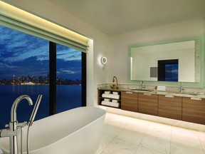 Guests can soak in the view of the city skyline at night from the huge soaker tub.