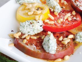 Sliced heirloom tomatoes are crowned by a sprinkling of pine nuts and dollops of herbed ricotta. Photo: Janis Nicolay