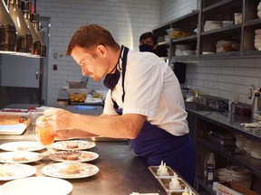 Chef Ned Bell finishes plates in his dream kitchen at the restaurant at the Naramata Inn.