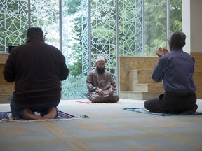 Imam Yahya Momla (centre) leads prayers at the Burnaby Mosque on July 22, 2020.
