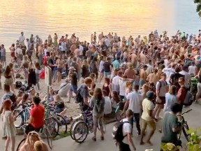 Scores of people held a party on Third Beach in Vancouver Tuesday night despite pleas from health officials to maintain social distancing protocols as the number of COVID-19 cases spike in B.C.