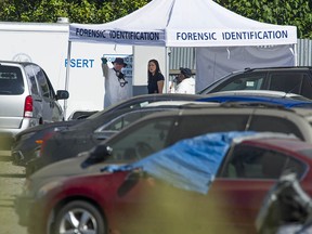 Members of IHIT and Burnaby Fire and Rescue Services investigate Thursday morning, July 30, 2020 after a body was found in a car at Mundies Towing yard in Burnaby,  Wednesday.