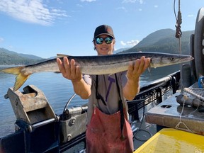 Tyler Vogrig with the one-metre, 12-pound Pacific barracuda he caught in Alberni Inlet this month.