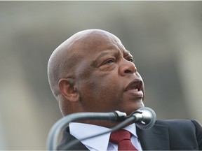 In this file photo taken on February 27, 2013 Rep. John Lewis, D-GA, speaks during a press conference in front of the US Supreme Court on Capitol Hill in Washington, DC. - John Lewis, the non-violent civil rights warrior who marched with Martin Luther King Jr and nearly died from police beatings before serving for decades as a US congressman, has died at age 80, House colleagues said July 17, 2020. In December 2019, he was diagnosed with pancreatic cancer.