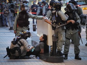 Police detained a protester during a march marking the anniversary of the Hong Kong handover from Britain to China, Wednesday, July. 1, 2020, in Hong Kong. Hong Kong marked the 23rd anniversary of its handover to China in 1997, and just one day after China enacted a national security law that cracks down on protests in the territory.