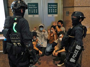 People detained by riot police during a march against national security law at the anniversary of Hong Kong's handover to China from Britain in Hong Kong, China July 1, 2020.