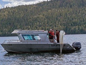 Researchers from the University of Northern British Columbia use a net to collect plankton for metal analysis from Quesnel Lake as part of research into the Mount Polley mine dam collapse that will continue for years.