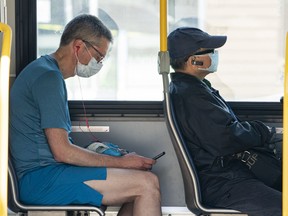 Transit users wear masks while riding a bus in Vancouver.