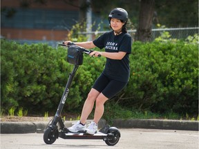 Nancy Mo rides an electric scooter in Vancouver.