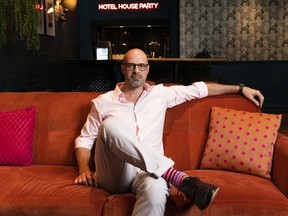 Don Falconer of the Hotel Belmont poses for a photo in The Living Room, a lounge that has been converted into a food-business.