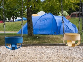 Swings sit empty in front of a growing tent city in Strathcona Park in Vancouver, BC, July, 28, 2020.