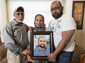 Baljit, Jasbir and Amar Marock hold a photo of their son and brother Devon who was killed in a fatal car accident in Kelowna last summer.