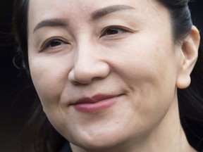 In this Jan. 21, 2020, file photo, Huawei chief financial officer Meng Wanzhou, who is out on bail and remains under partial house arrest after she was detained last year at the behest of American authorities, leaves her home to attend a hearing in British Columbia Supreme Court, in Vancouver. New court documents accuse the United States president of "poisoning" the extradition case against Huawei's CFO to further the American trade agenda.