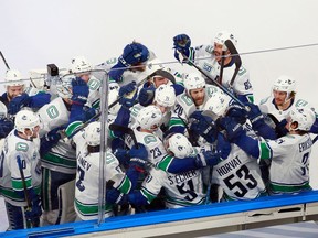 The Vancouver Canucks celebrate their Game 2 overtime victory on Friday against the St. Louis Blues at Rogers Place in Edmonton. The Canucks won 4-3 to grab a 2-0 lead in the best-of-seven series. Game 3 is Sunday.