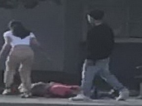 A teen rushes to the boy's aid as the male suspect begins to walk away.