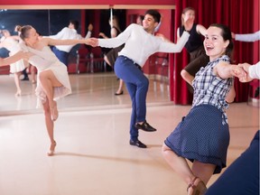 Glad partners dancing the lindy hop.