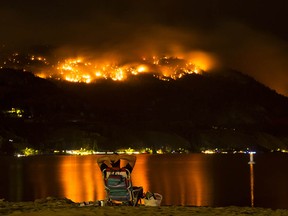 Flames from the Christie Mountain wildfire along Skaha Lake near Penticton, light up the night sky on Wednesday, Aug. 19.