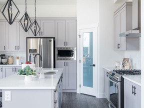 At Foxridge Homes' Westbrooke development in Langley, light grey cabinets and black matte hardware were combined to personalize this kitchen.