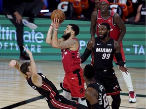Fred VanVleet of the Toronto Raptors takes a shot as Miami Heat's Goran Dragic tries to draw the foul during NBA action earlier this week in Lake Buena Vista, Fla. The NBA's return to action has been a safe one so far.