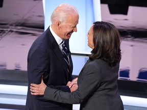 In this file photo taken on July 31, 2019, Democratic presidential candidate Joe Biden and Senator Kamala Harris greet each other at the Fox Theatre in Detroit.