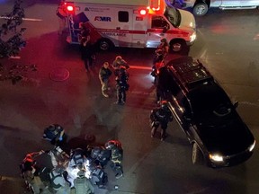 Medics and police personnel (bottom) surround the victim of a shooting in Portland on Aug. 29, 2020, in this still image obtained from a social media video.