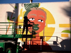 Pearl Low, pictured here working on a mural for Pride 2020, is one of this year's participants in the Vancouver Mural Festival.