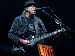 In this file photo taken on July 6, 2018 Neil Young performs on stage for his first time in Quebec City during Festival d'Ete.