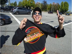 Fan Christian Trinidad sports his Canuck colours at 72nd and Scott Road in Surrey on Aug. 15, 2020.