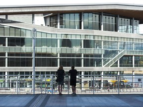 A couple at Canada Place look toward the Vancouver Convention Centre (West). Both sites are normally teeming with tourists at this time of year, but B.C. tourist attractions that rely on international visitors (like Vancouver) are hard hit because of the pandemic.