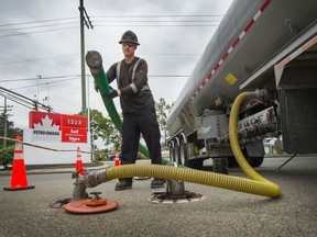 Fuel delivery driver, David Pirzek fills underground tanks at PetroCan in North Delta, BC, July 4, 2019.