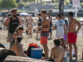 Beach-goers flock to Kits Beach in Vancouver, BC, August, 9, 2020.