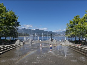 Young kids play in the water park at Harbour Green Park while a rainbow forms from the spay of the water in Vancouver.