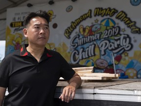 Raymond Cheung, owner of the Richmond Night Market, poses on the main stage inside the market. Work had just begun rebuilding the stage from last year's theme, Chill Party, to this year's 20th anniversary theme when worked halted because of the pandemic.