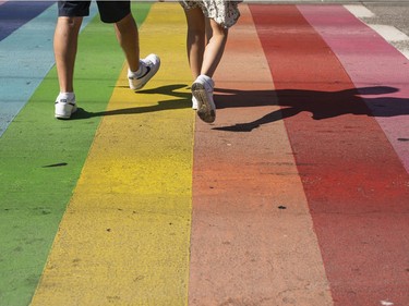 Pedestrians cross at the rainbow crosswalk at the corner of Bute and Davie Street in Vancouver, BC, August, 2, 2020.