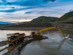 An excavator dredging out a channel at the entrance to one of the river diversion tunnels on B.C. Hydro's Site C dam project on the Peace River near Fort St. John, in August of 2020. River diversion, scheduled to begin in September, 2020, is the next major milestone for the hydroelectric facility.