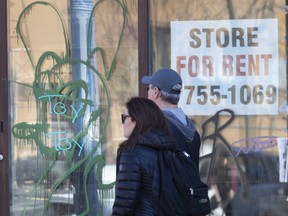 A storefront window of a closed business on Danforth Avenue.