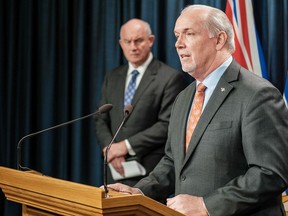 Premier John Horgan, with Public Safety Minister Mike Farnworth, announce an extension of B.C.'s state of emergency on Aug. 16, 2020.