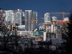 Construction cranes tower above condos under construction near southeast False Creek in Vancouver.