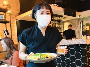 Server Sarah Wong delivers coconut milk cakes at Do Chay in Yaletown, the sister to the popular vegetarian restaurant on Kingsway in Vancouver. Photo: Mia Stainsby.