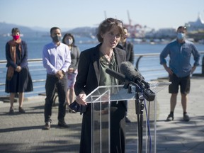 B.C. Green party Leader Sonia Furstenau, backed by Green candidates, speaks at a news conference Sept. 28 on the seawall at Harbour Green Park in Vancouver.