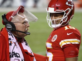 Quarterback Patrick Mahomes of the Kansas City Chiefs smiles at head coach Andy Reid during the fourth quarter of Thursday's NFL opener against the Houston Texans at Arrowhead Stadium in Kansas City, Miss.