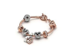 Pandora Moments Snake Chain T-Bar Bracelet with assorted charms.