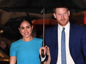 In this file photo taken on March 5, 2020 Britain's Prince Harry, Duke of Sussex (R) and Meghan, Duchess of Sussex arrive to attend the Endeavour Fund Awards at Mansion House in London.