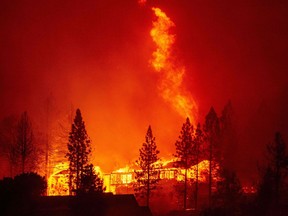 A home is engulfed in flames during the Creek Fire in the Tollhouse area of unincorporated Fresno County, Calif., early on Sept. 8, 2020.