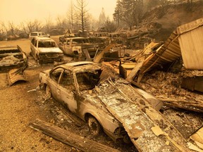 Burned vehicles smoulder at a residence during the Creek fire in an unincorporated area of Fresno County, Calif., on Sept. 8, 2020.