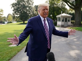 U.S. President Donald Trump talks to reporters as he departs for campaign travel to Minnesota from the South Lawn at the White House in Washington, D.C., Friday, Sept. 18, 2020.